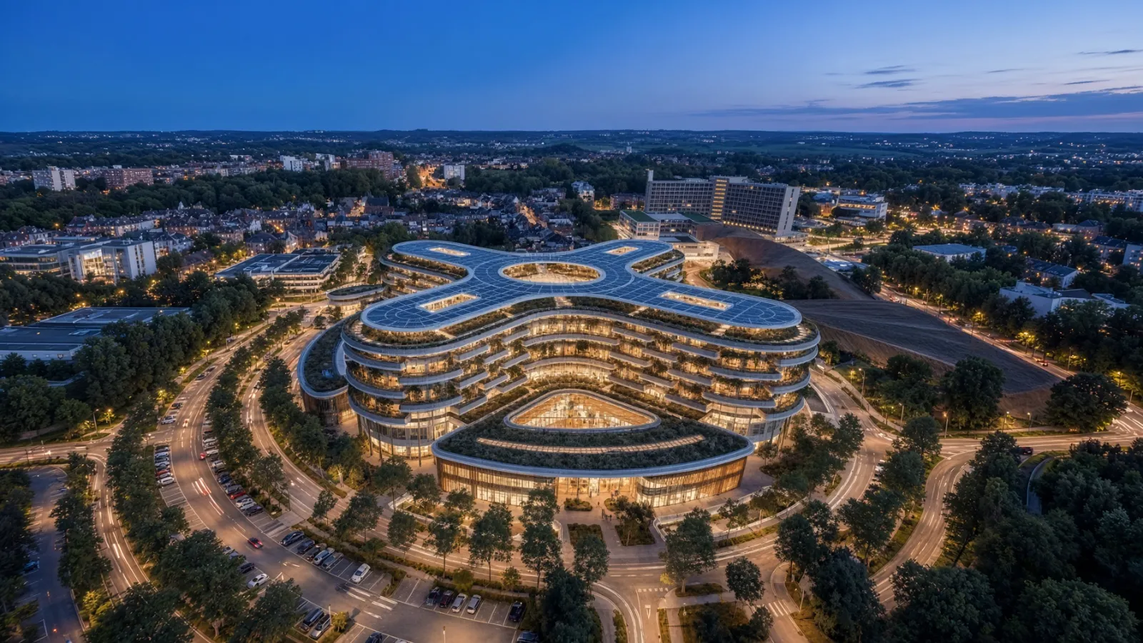 Hospital contemporáneo iluminado al atardecer, vista aérea